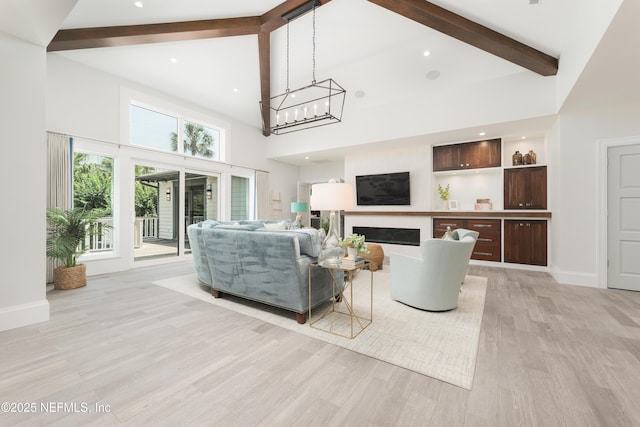 365 8th St, Atlantic Beach, FL 32233 - living room featuring beamed ceiling, high vaulted ceiling, light wood-type flooring, a glass covered fireplace, and recessed lighting
