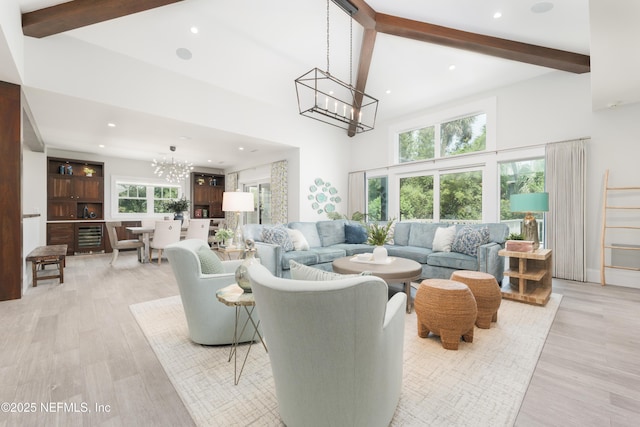 365 8th St, Atlantic Beach, FL 32233 - living area with a chandelier, high vaulted ceiling, beamed ceiling, light wood-style flooring, and beverage cooler