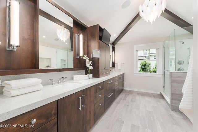 365 8th St, Atlantic Beach, FL 32233 - full bathroom featuring double vanity, a stall shower, and wood finished floors