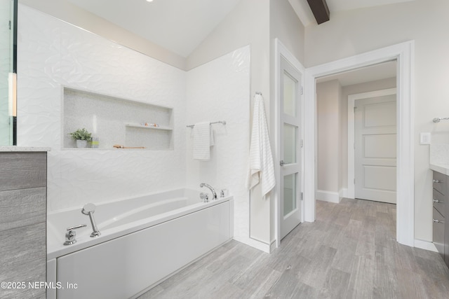 365 8th St, Atlantic Beach, FL 32233 - bathroom with a bath, vanity, wood finished floors, and vaulted ceiling