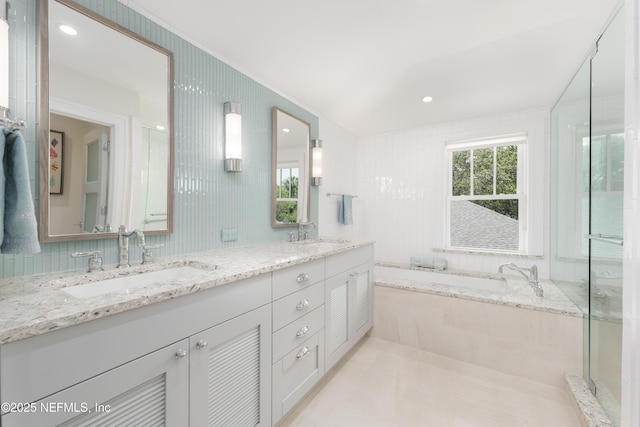 365 8th St, Atlantic Beach, FL 32233 - full bathroom with double vanity, a garden tub, and tile walls