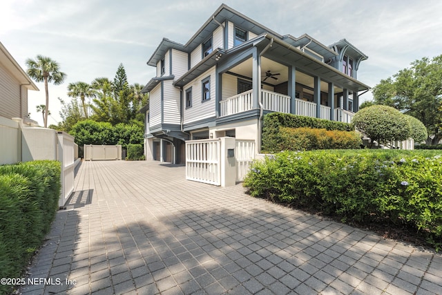 365 8th St, Atlantic Beach, FL 32233 - view of property exterior featuring a ceiling fan, a gate, a garage, and a balcony