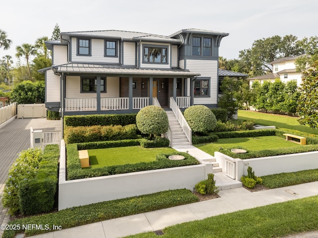 365 8th St, Atlantic Beach, FL 32233 - view of front facade featuring a standing seam roof, a metal roof, a porch, stairway, and a gate