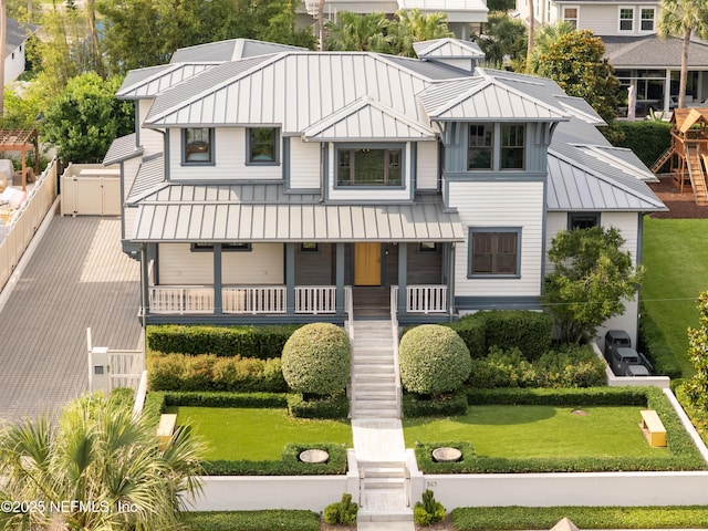 365 8th St, Atlantic Beach, FL 32233 - view of front of home with a standing seam roof, a metal roof, covered porch, and a front yard