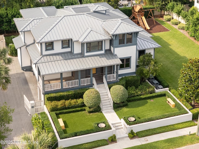 365 8th St, Atlantic Beach, FL 32233 - view of front of property with a standing seam roof, a metal roof, a front lawn, stairway, and covered porch
