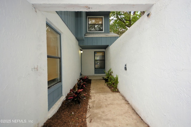 1266 Mayport Landing Cir, Jacksonville, FL 32233 - doorway to property featuring stucco siding, a standing seam roof, and metal roof