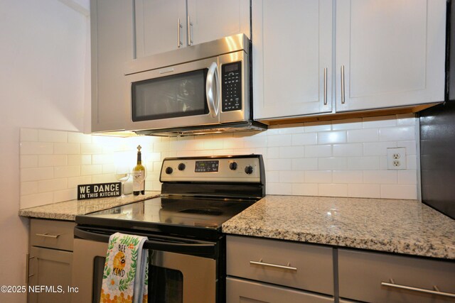 1266 Mayport Landing Cir, Jacksonville, FL 32233 - kitchen featuring appliances with stainless steel finishes, gray cabinets, backsplash, and light stone counters
