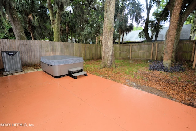 1266 Mayport Landing Cir, Jacksonville, FL 32233 - fenced backyard with a hot tub, a patio, and central AC