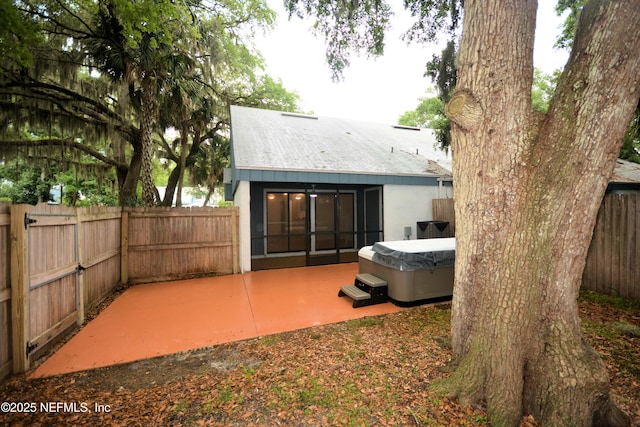 1266 Mayport Landing Cir, Jacksonville, FL 32233 - rear view of house with a hot tub, a patio, and a fenced backyard