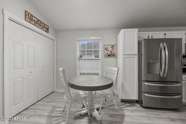 11214 Bentley Trace Ln E, Jacksonville, FL 32257 - dining room with light wood finished floors and vaulted ceiling