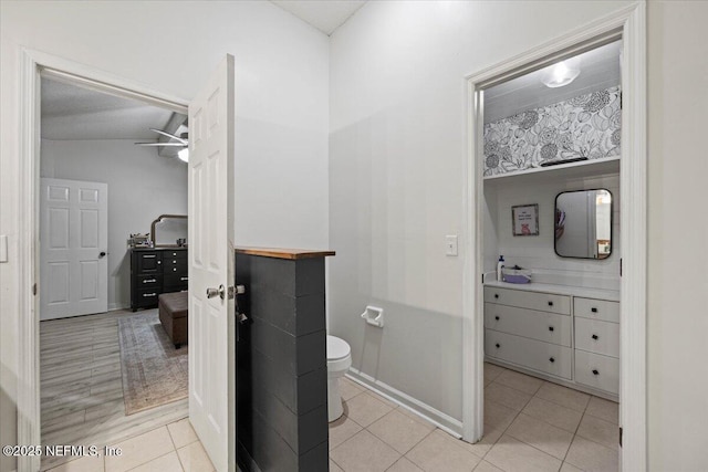 11214 Bentley Trace Ln E, Jacksonville, FL 32257 - bathroom featuring toilet, vanity, tile patterned flooring, baseboards, and a ceiling fan