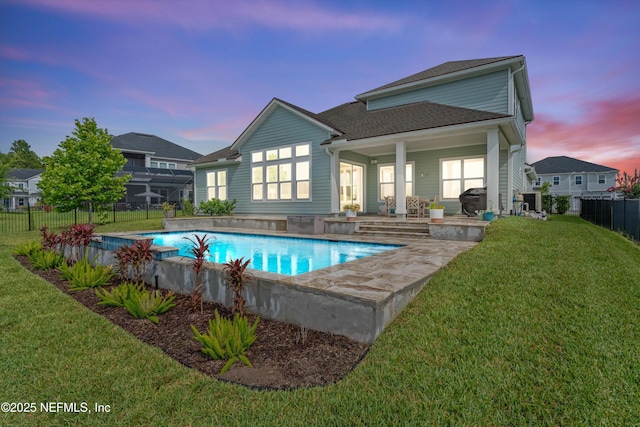 46 Hydrilla Ct, Saint Augustine, FL 32095 - back of house at dusk with a fenced backyard and a shingled roof