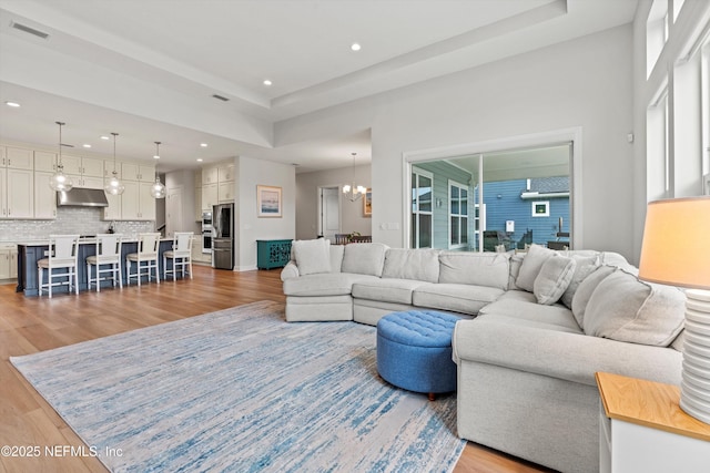 46 Hydrilla Ct, Saint Augustine, FL 32095 - living room featuring light wood-style flooring, recessed lighting, a chandelier, and a raised ceiling