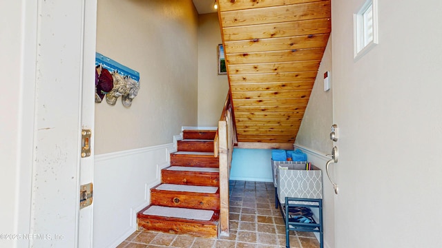 23 Moody Dr, Palm Coast, FL 32137 - staircase featuring stone finish floors and a wainscoted wall