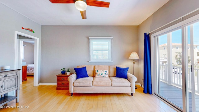 23 Moody Dr, Palm Coast, FL 32137 - living room featuring a ceiling fan, wood-type flooring, and baseboards