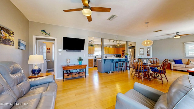 23 Moody Dr, Palm Coast, FL 32137 - living area with ceiling fan, light wood-style flooring, healthy amount of natural light, and wine cooler