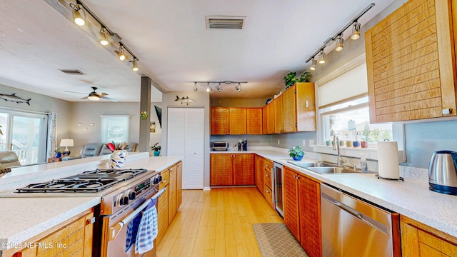 23 Moody Dr, Palm Coast, FL 32137 - kitchen with appliances with stainless steel finishes, a sink, rail lighting, open floor plan, and ceiling fan