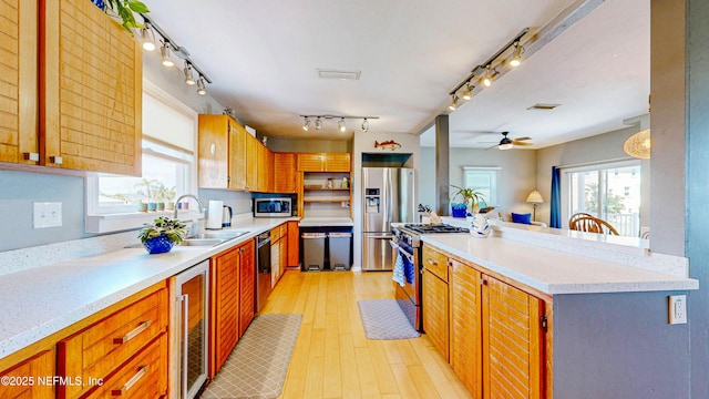 23 Moody Dr, Palm Coast, FL 32137 - kitchen with appliances with stainless steel finishes, a sink, wine cooler, light countertops, and rail lighting