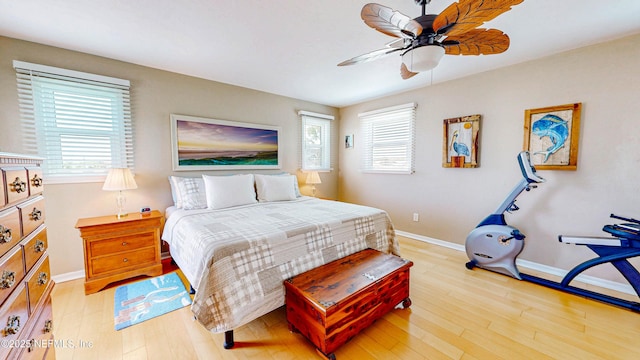23 Moody Dr, Palm Coast, FL 32137 - bedroom with multiple windows, light wood-type flooring, baseboards, and a ceiling fan