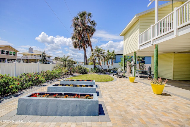 23 Moody Dr, Palm Coast, FL 32137 - fenced backyard with a vegetable garden and a patio