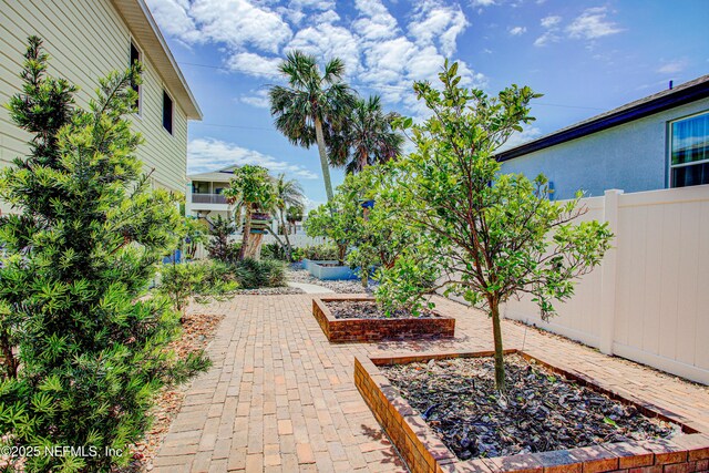 23 Moody Dr, Palm Coast, FL 32137 - view of patio featuring a garden