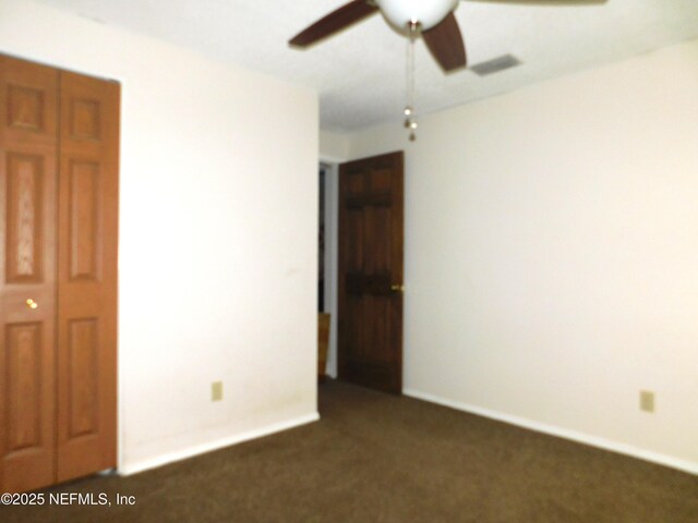 2718 Tina Ln, Middleburg, FL 32068 - unfurnished bedroom featuring dark carpet, baseboards, and ceiling fan