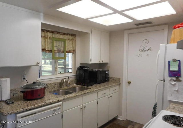 7670 SW 112th Ln, Ocala, FL 34476 - kitchen with a sink, freestanding refrigerator, black microwave, stainless steel dishwasher, and white cabinets