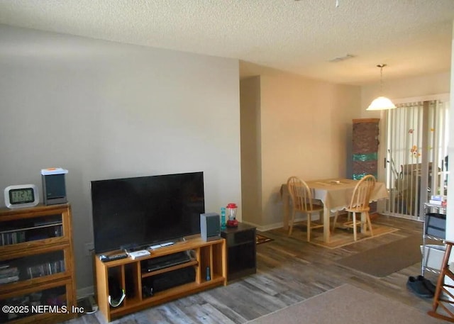 7670 SW 112th Ln, Ocala, FL 34476 - living room featuring wood finished floors, a textured ceiling, and baseboards