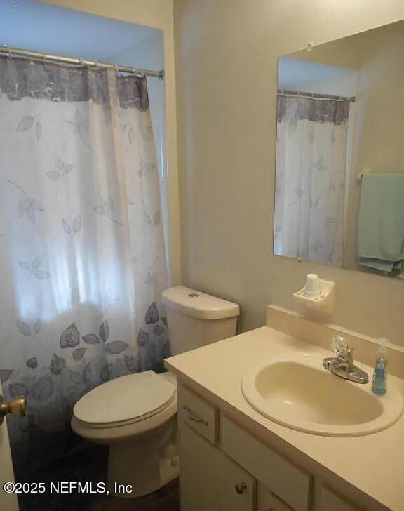 7670 SW 112th Ln, Ocala, FL 34476 - bathroom with vanity, toilet, and curtained shower