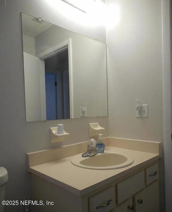 7670 SW 112th Ln, Ocala, FL 34476 - half bathroom featuring vanity and toilet