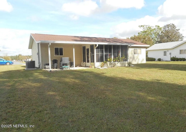 7670 SW 112th Ln, Ocala, FL 34476 - back of house with central AC, a lawn, a sunroom, and a patio