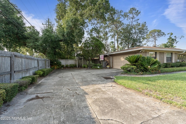 2364 Smullian Trl S, Jacksonville, FL 32217 - view of side of property featuring brick siding, driveway, an attached garage, and central AC unit