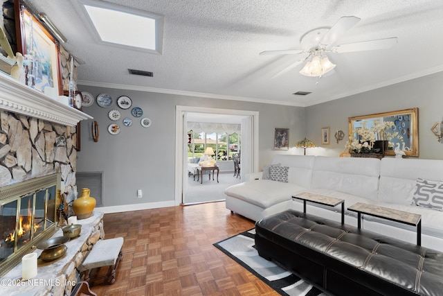 2364 Smullian Trl S, Jacksonville, FL 32217 - living room featuring ceiling fan, a textured ceiling, a fireplace, baseboards, and ornamental molding