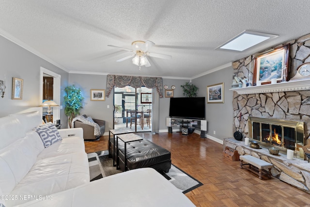 2364 Smullian Trl S, Jacksonville, FL 32217 - living area featuring a ceiling fan, a textured ceiling, a fireplace, crown molding, and baseboards