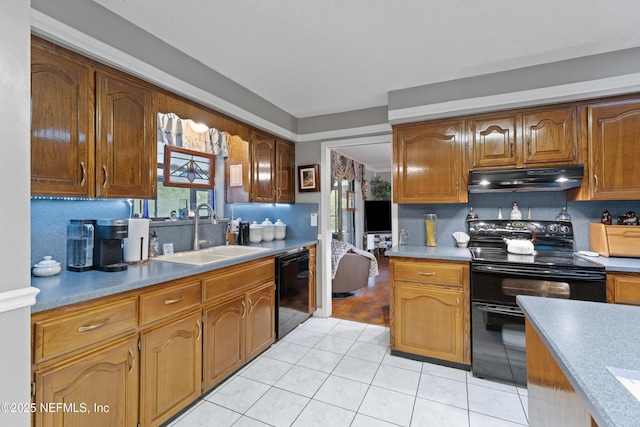 2364 Smullian Trl S, Jacksonville, FL 32217 - kitchen with black appliances, under cabinet range hood, a sink, brown cabinets, and light tile patterned floors