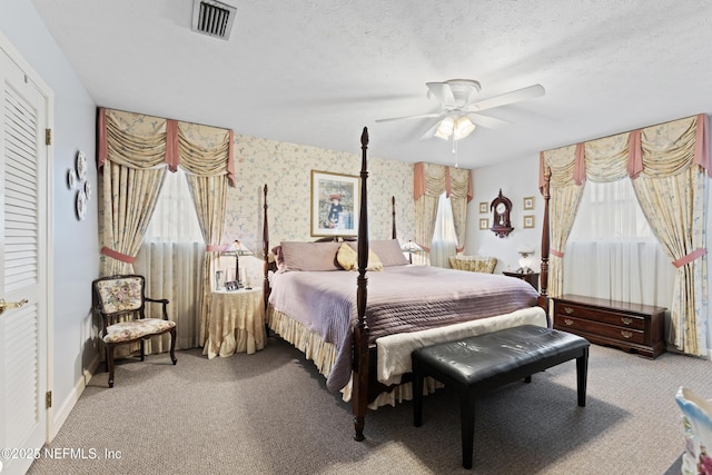 2364 Smullian Trl S, Jacksonville, FL 32217 - bedroom with carpet, a ceiling fan, wallpapered walls, and a textured ceiling
