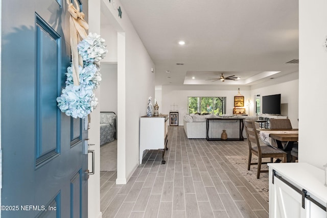 85600 Stonehurst Pkwy, Fernandina Beach, FL 32034 - entrance foyer featuring a raised ceiling, a ceiling fan, recessed lighting, light wood-style floors, and baseboards