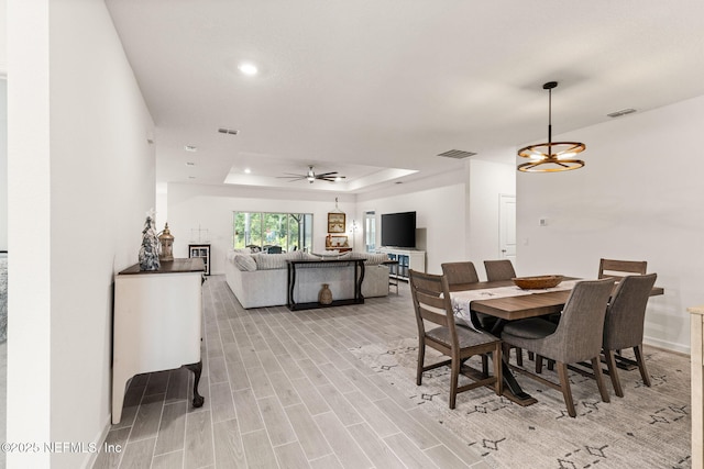 85600 Stonehurst Pkwy, Fernandina Beach, FL 32034 - dining area with a raised ceiling, ceiling fan, recessed lighting, light wood-style floors, and baseboards