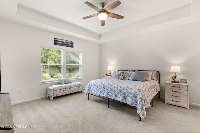 85600 Stonehurst Pkwy, Fernandina Beach, FL 32034 - carpeted bedroom featuring a tray ceiling, baseboards, and ceiling fan