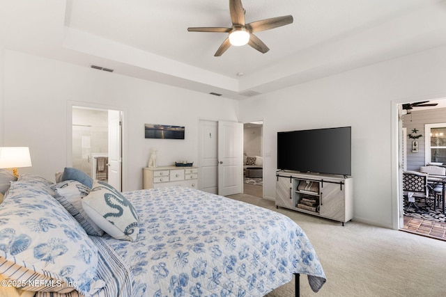 85600 Stonehurst Pkwy, Fernandina Beach, FL 32034 - bedroom featuring light colored carpet, ensuite bath, a raised ceiling, and ceiling fan