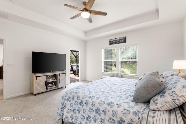 85600 Stonehurst Pkwy, Fernandina Beach, FL 32034 - bedroom featuring access to outside, light carpet, baseboards, a raised ceiling, and a ceiling fan
