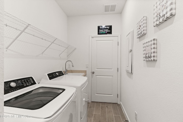 85600 Stonehurst Pkwy, Fernandina Beach, FL 32034 - laundry area with washing machine and dryer, wood tiled floors, and baseboards