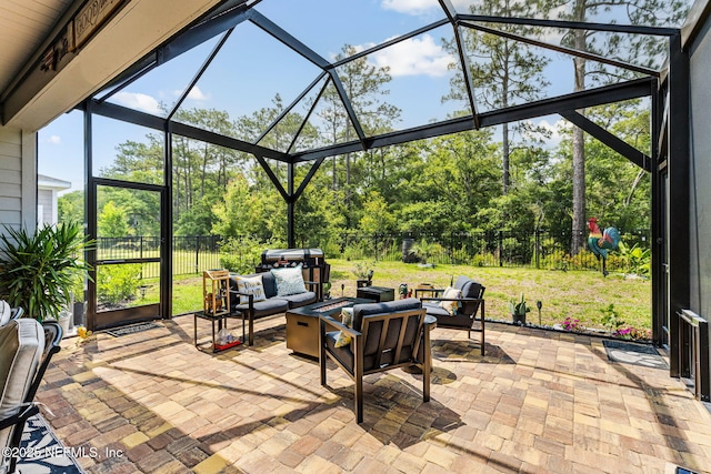 85600 Stonehurst Pkwy, Fernandina Beach, FL 32034 - view of patio with an outdoor living space, a lanai, and view of wooded area