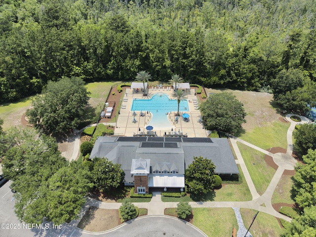 85600 Stonehurst Pkwy, Fernandina Beach, FL 32034 - drone / aerial view of a pool and a heavily wooded area