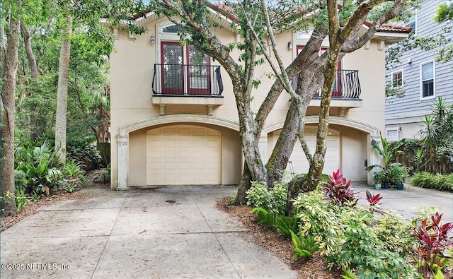 2049 Seminole Rd, Atlantic Beach, FL 32233 - view of front of house with a balcony, stucco siding, an attached garage, and concrete driveway