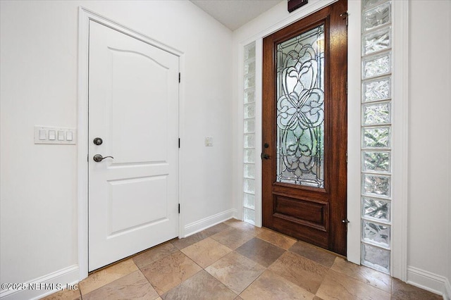 2049 Seminole Rd, Atlantic Beach, FL 32233 - foyer entrance with baseboards and light stone finish flooring