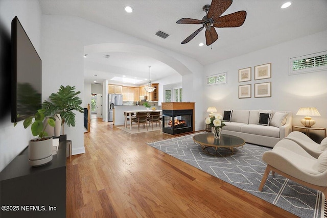 2049 Seminole Rd, Atlantic Beach, FL 32233 - living room featuring arched walkways, ceiling fan, light wood-type flooring, and recessed lighting