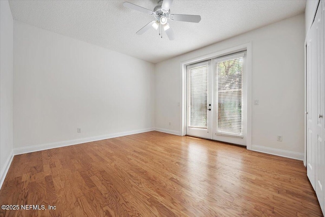 2049 Seminole Rd, Atlantic Beach, FL 32233 - empty room featuring light wood-style floors, french doors, ceiling fan, and a textured ceiling