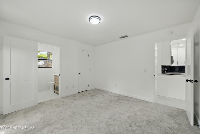 494 Acacia St, Saint Augustine Beach, FL 32080 - unfurnished bedroom with light carpet, ensuite bath, and baseboards