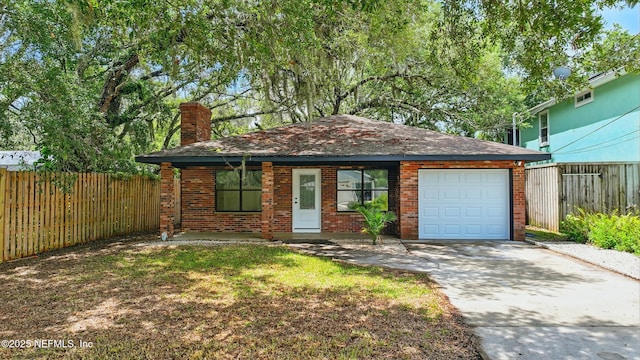 494 Acacia St, Saint Augustine Beach, FL 32080 - view of front of house with concrete driveway, an attached garage, brick siding, a chimney, and roof with shingles